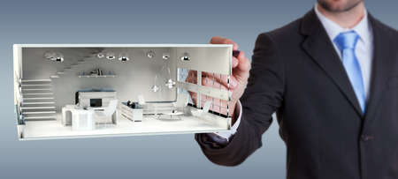 Businessman on blurred background drawing white 3D rendering apartment planの写真素材