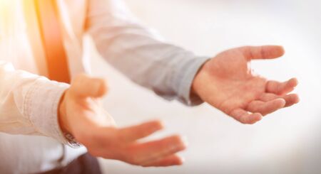 Businessman on blurred background showing his empty handの写真素材