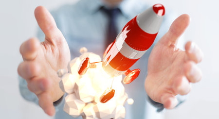 Businessman on blurred background holding red rocket in his hand 3D rendering