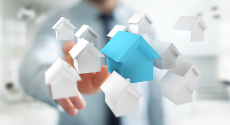 Businessman on blurred background using 3D rendered small white and blue housesの写真素材