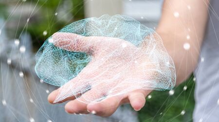 Businessman holding digital human brain with cell and neurons activity 3D renderingの写真素材