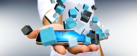 Businessman on blurred background holding floating blue shiny cube network 3D renderingの写真素材