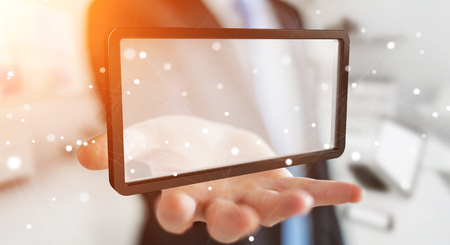 Businessman on blurred background using digital screens tablet 3D renderingの写真素材