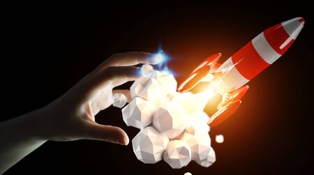 Businessman on blurred background holding red rocket in his hand 3D renderingの写真素材