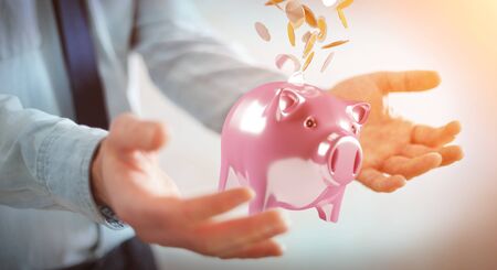 Businessman on blurred background holding piggy bank with flying coins going inside 3D renderingの写真素材