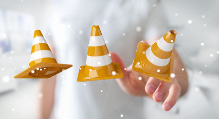 Businessman on blurred background using digital 3D rendering under construction signsの写真素材