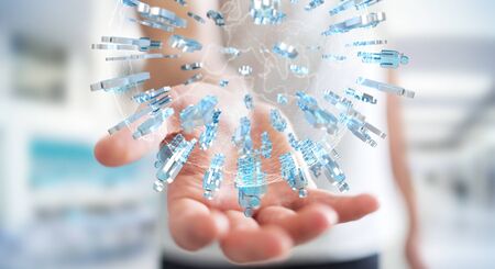 Businessman on blurred background holding 3D rendering group of people surrounding planet Earthの写真素材