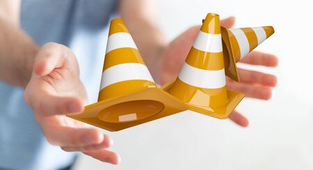 Businessman on blurred background using digital 3D rendering under construction signsの写真素材