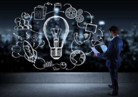 Businessman watching innovation sketch on a rooftop with a city view 3D renderingの写真素材