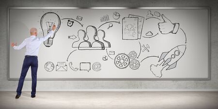 Businessman in modern interior drawing a project sketch on a board 3D renderingの写真素材