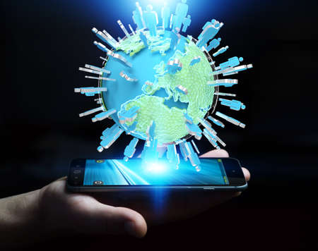 Businessman on blurred background holding 3D rendering group of people surrounding planet Earthの写真素材