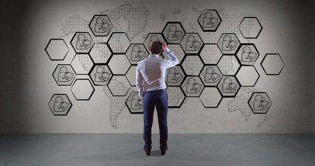Businessman in modern interior watching internet security interface sketch on a wall 3D rendering