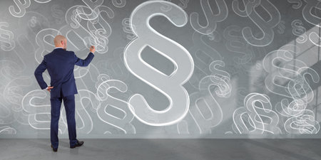 Businessman in modern interior drawing law paragraph symbol on a wall 3D rendering