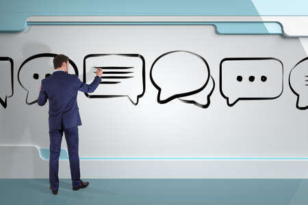 Businessman in modern interior drawing discussion icons sketch on a board 3D renderingの写真素材