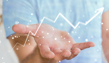 Businessman on blurred background holding hand-drawn arrow going upの写真素材