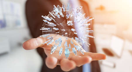 Businessman on blurred background holding 3D rendering group of people surrounding planet Earthの写真素材