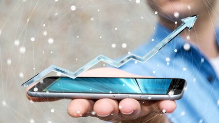 Businessman holding digital blue arrow over mobile phone 3D renderingの写真素材
