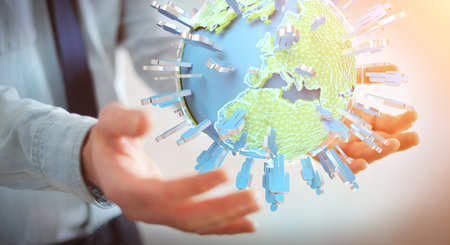 Businessman on blurred background holding 3D rendering group of people surrounding planet Earth
