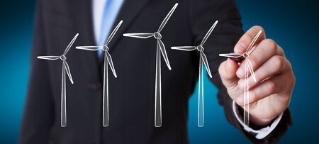 Businessman on blurred background drawing renewable energy sketchの写真素材