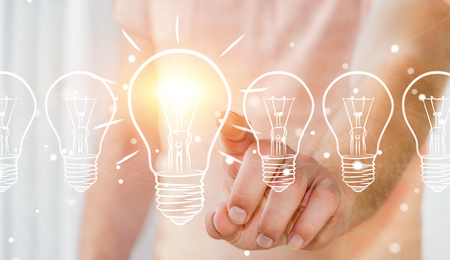 Businessman on blurred background touching a sketch lightbulbの写真素材
