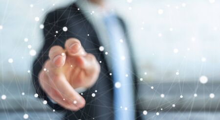 Businessman on blurred background touching floating dot network 3D renderingの写真素材