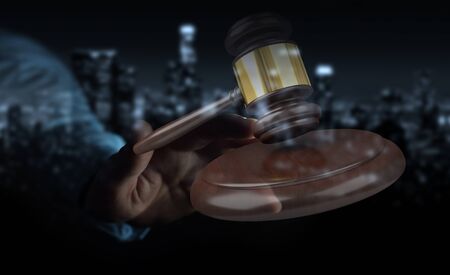 Businessman on blurred background with justice hammer 3D renderingの写真素材