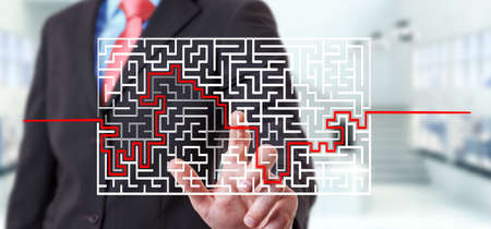 Businessman on blurred background searching solution of a complicated mazeの写真素材