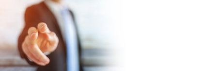 Panorama view of businessman pointing finger on blurred backgroundの写真素材