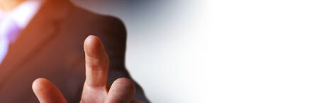Panorama view of businessman pointing finger on blurred backgroundの写真素材