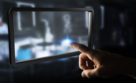 Businessman on blurred background using digital screens tablet 3D renderingの写真素材