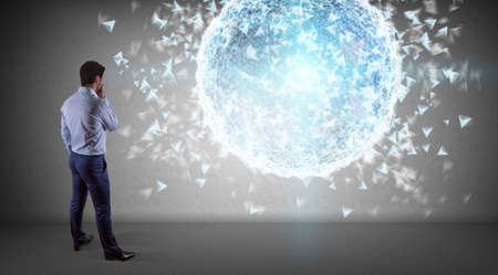 Businessman in modern interior using digital planet earth interface on a wall 3D renderingの写真素材