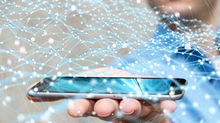 Businessman on blurred background holding flying network over phone 3D renderingの写真素材
