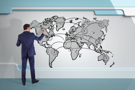 Businessman in modern interior drawing manuscript world map connection on a board 3D renderingの写真素材