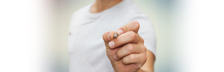 Panorama view of a businessman writing with a pen on a digital screenの写真素材