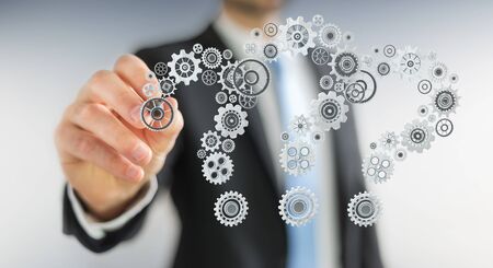 Businessman on blurred background drawing question marks gear 3D renderingの写真素材