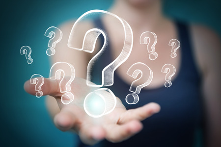 Businesswoman on blurred background touching and holding hand drawn question marksの写真素材