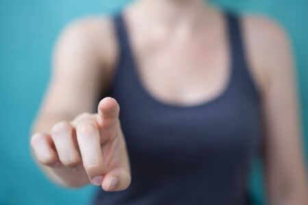 Businesswoman pointing finger on blurred backgroundの写真素材