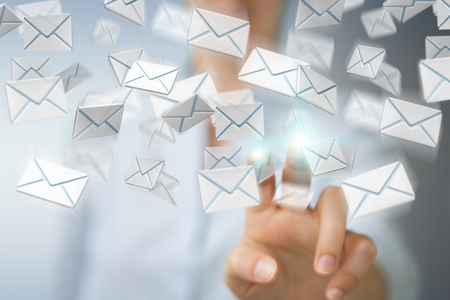 Businesswoman on blurred background holding and touching 3D rendering flying emailの写真素材