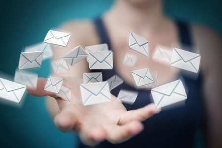 Businesswoman on blurred background holding and touching 3D rendering flying emailの写真素材