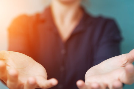 Businesswoman opening both hand on blurred background