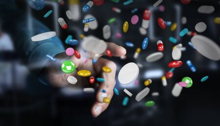Businessman on blurred background holding and touching floating medicine pills 3D renderingの写真素材