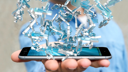 Businessman on blurred background holding 3D rendering group of blue peopleの写真素材