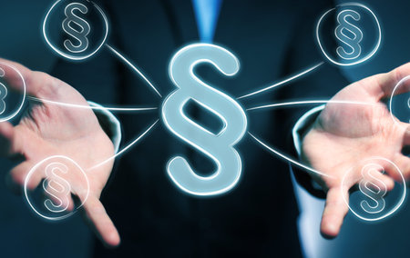 Businessman on blurred background holding law protection right symbol