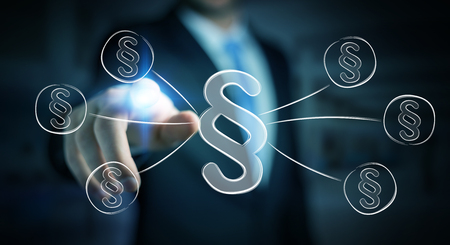 Businessman on blurred background touching law protection right symbolの写真素材