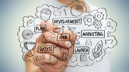 Businessman on blurred background drawing manuscript project presentation with a penの写真素材