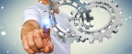 Businessman on blurred background using floating gear icons 3D renderingの写真素材