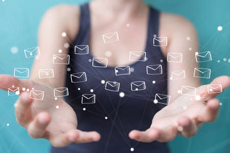 Businesswoman on blurred background holding and touching floating emails sketchの写真素材