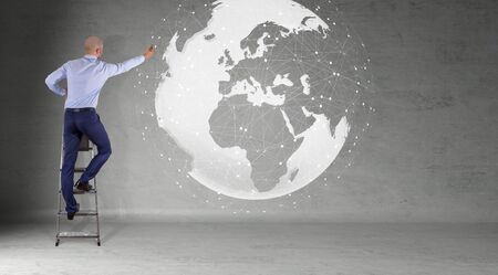 Businessman in modern interior using digital planet earth interface on a wall 3D renderingの写真素材
