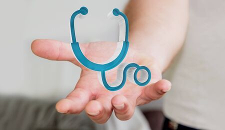 Businessman on blurred background holding and touching medical icon 3D renderingの写真素材