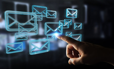 Businessman on blurred background holding and touching floating emails 3D rendering